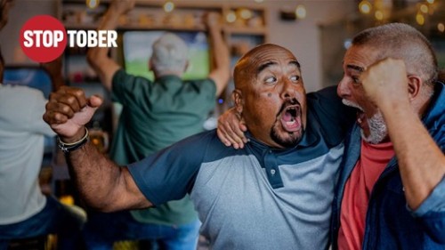 STOP TOPBER logo in corner with 2 men in the forefront hugging and cheering.